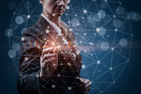 Business woman working in a network of connections on a blue background.の写真素材