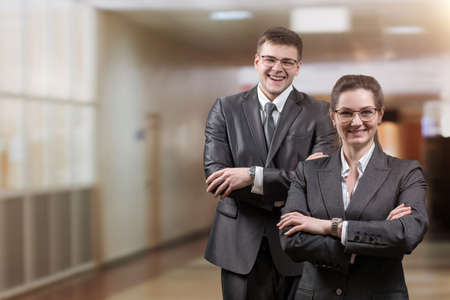 Man and woman in business suits on a blurred background.の写真素材