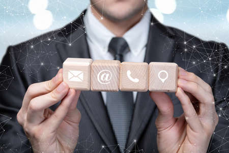 Businessman showing contacts online on blurred background.の写真素材