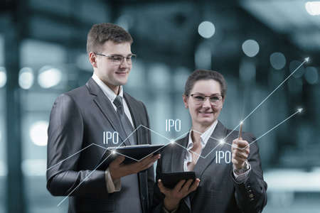 Businessmen looking for Initial Public Offering dots on a virtual screen.
