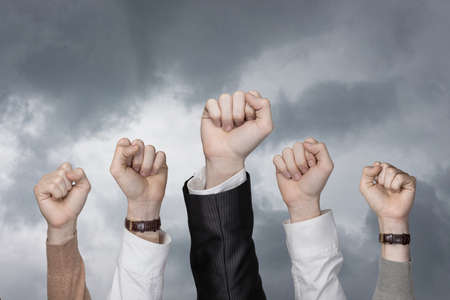 Concept of teamwork of the success in business team.Raised hands against the sky businessmen.