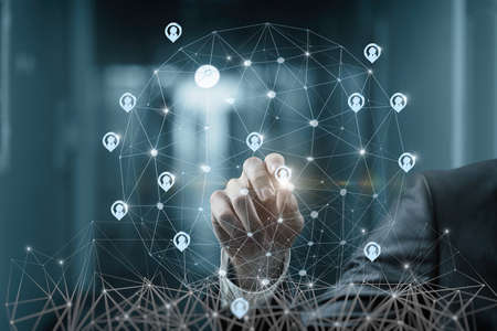 Businessman on virtual screen working with client base online on blurred background.の写真素材