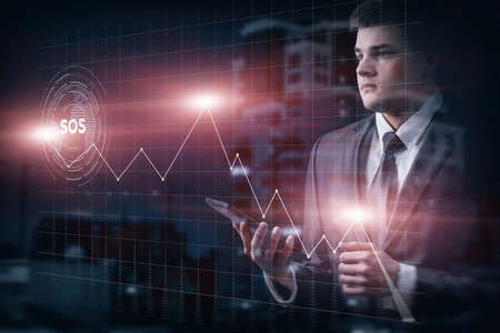 Business man analyzes financial fall chart during sos signal.