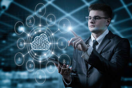 Businessman working with network computing cloud on virtual computer screen.