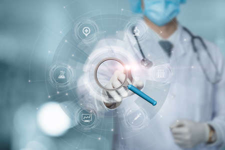 medical research concept. Doctor clicks on magnifying glass on virtual computer screen.の写真素材