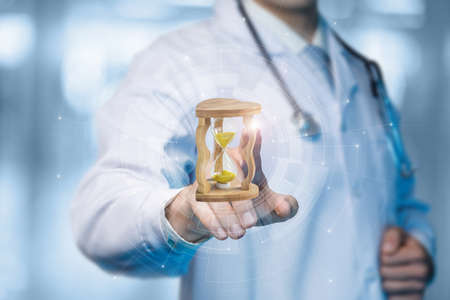 Concepts of timely medical assistance. Doctor clicks on the hourglass.の写真素材
