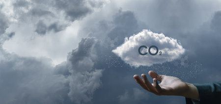 Concept protection of nature CO2. The hand shows the clouds with the inscription CO2 against the sky...