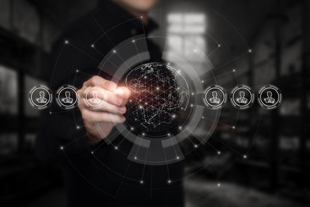 Businessman draw on a virtual computer screen a global system of business relations.の写真素材