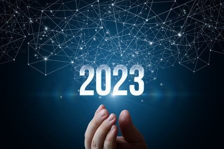 Hand shows new year 2023 appearing from the network of connections.
