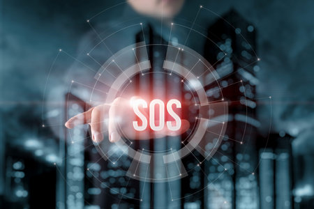 A man clicks on the SOS button on a virtual computer screen.の写真素材