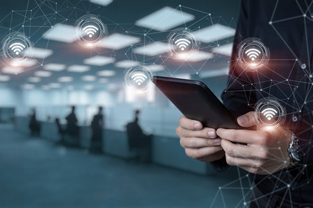 A man on a tablet connects to a wireless wifi network in a call center.