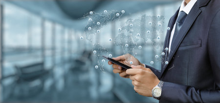 Businessman working global business network using mobile device.