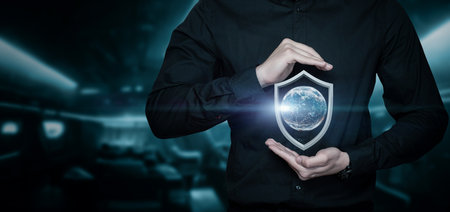 The concept of protecting the world. A man protects the globe with his hands.