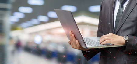 Businessman working at a computer on a blurred background on the Internet.の写真素材