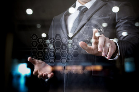 Businessman clicking on internet of things data transmission in global network.の写真素材