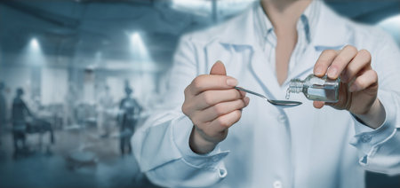 Doctor pouring medicine into the cover for the treatment of the disease in the hospital.の写真素材