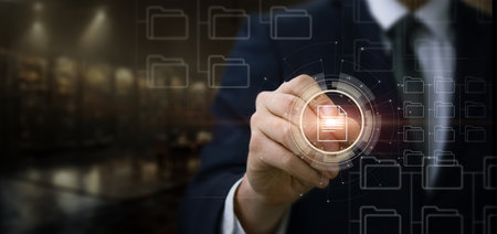 Businessman works with files on a virtual computer screen.の写真素材