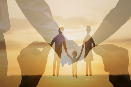 Concepts of love peace and family. Double exposure of the family against the backdrop of the sun and a couple in love.の写真素材