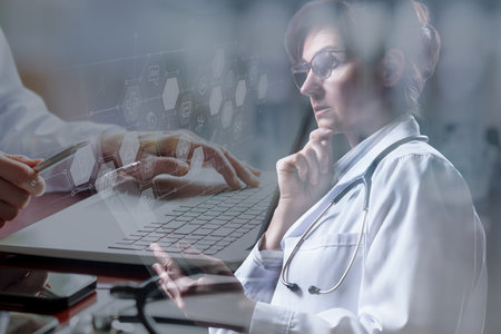 Double exposure of doctors meditating and working at computer in the office.