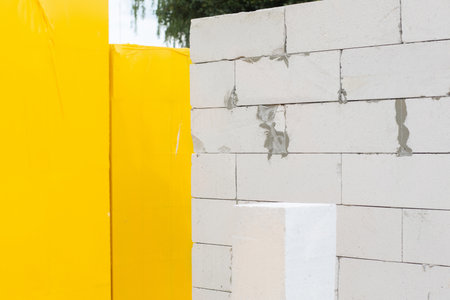 The wall is built from a gas block and a pallet on a blurred background.