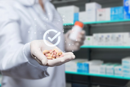 The concept of quality medicines in a pharmacy. The pharmacist shows pills in the background of the pharmacy.の写真素材