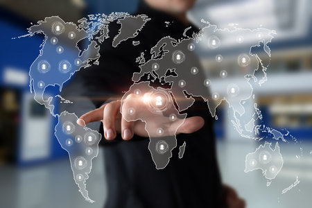 The manager works on a world map with his clients. Concept of modern business management technology.の写真素材