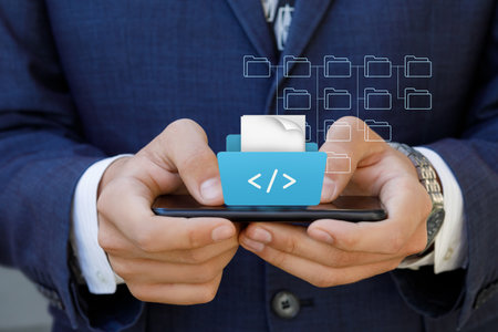 The concept of developing scripts on a mobile device. A developer works with scripts on a mobile phone.の写真素材