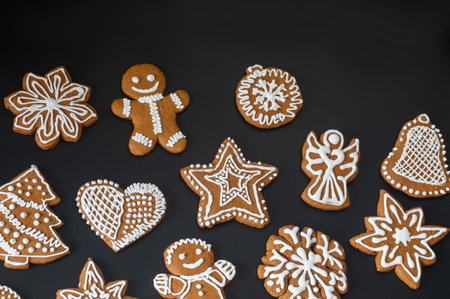 Christmas sweet gingerbread cookies on a dark background.