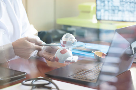 Doctor working with stethoscope and laptop computer in medical office.の写真素材