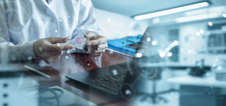 Doctor shows sample of germs on glass on table in office.の写真素材