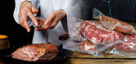 Cook prepares meat on dark background and packs vacuum bags.の写真素材