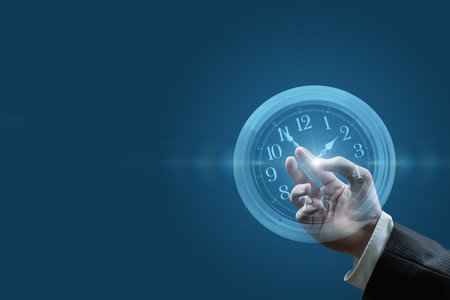 Concepts for business time management. Hand touches hands on blue background.の写真素材