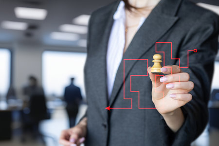 Manager shows a pawn against the backdrop of a maze on a virtual screen.の写真素材