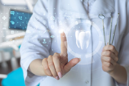 A dentist clicks on an icon of a tooth on a virtual screen on a computer.の写真素材