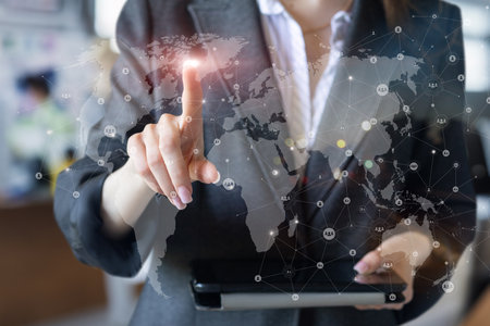 Managers working across the global network on a virtual screen.の写真素材