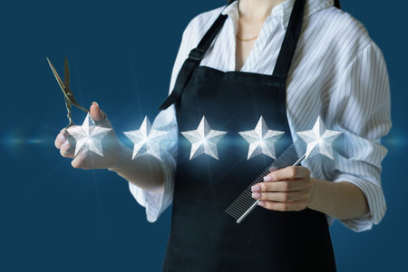 The concept of high quality hairdresser services. Hairdresser standing in front of five stars on blue background.の写真素材