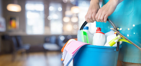 Cleaning woman with bucket and cleaning supplies on blurred background.の写真素材
