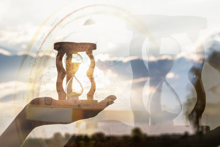 The concept of the elusive flow of time through the symbolism of the hourglass.の写真素材