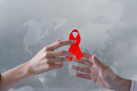 Understanding the global fight against AIDS through the symbolism of the red ribbon.の写真素材