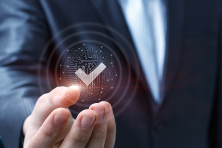 A businessman shows a check mark in his hand on a network of connections. The concept of success connection.の写真素材