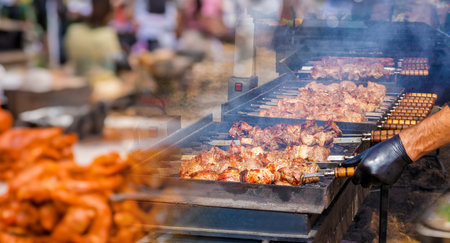 Street Grill Art. Grilling meat kebabs against a blurred background of street food.の写真素材