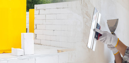 The concept of molar work. The concept of leveling and plastering a surface using a spatula.の写真素材