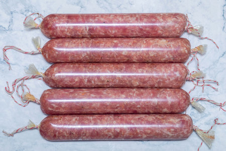 Homemade sausage preparations in natural or synthetic casings. Homemade sausage on a marbled...