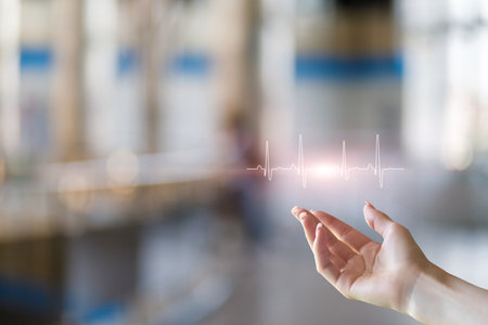 Biometrics of the Future. The hand pointing to the heart rate graph symbolizes the merging of human...