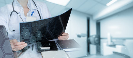 Diagnostics and analysis. A doctor studying an x-ray at his desk in his office.