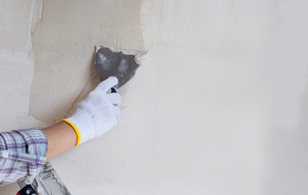 Wall puttingtying as a stage of house construction.の写真素材
