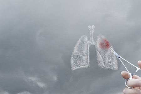 A person holds surgical scissors poised to interact with a holographic representation of lungs.の写真素材