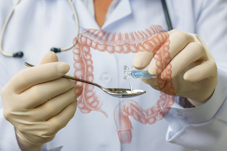 A healthcare worker in gloves holds a spoon and a small vial while demonstrating a medical procedure...