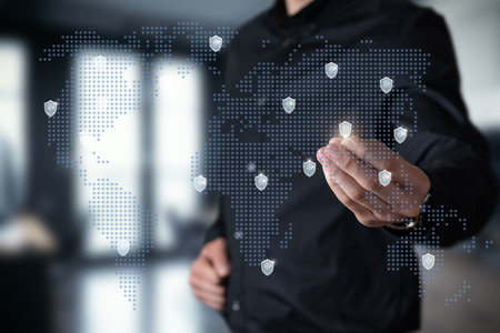 Global cybersecurity strategy in action. A professional interacts with a digital world map...