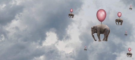 Elephants are seen gently floating in a cloudy sky, each one attached to a colorful balloon. The whimsical sight creates a surreal atmosphere reminiscent of dreams or fantasies.の写真素材